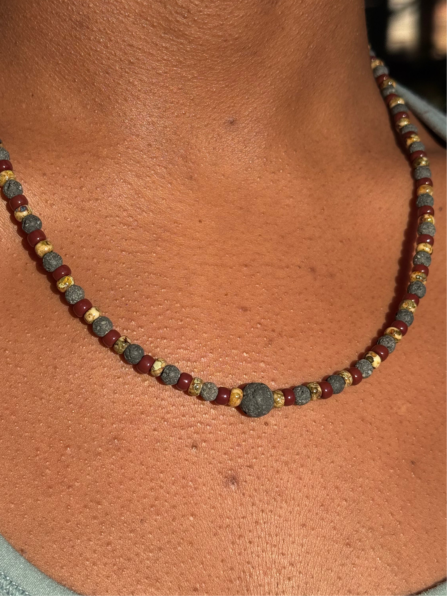 Necklace with multicolored beads on a person's neck