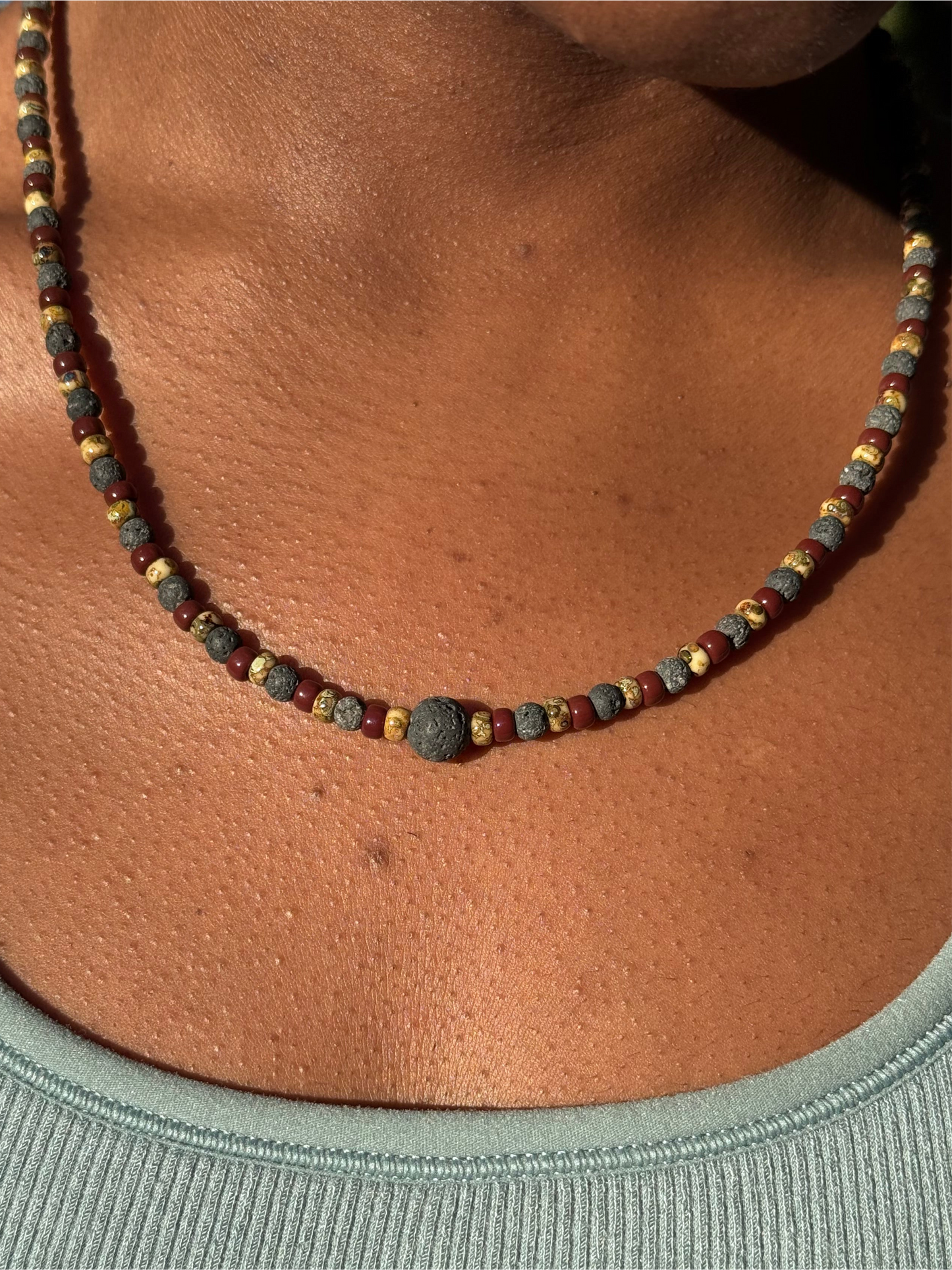 Necklace with small beads on a person's neck