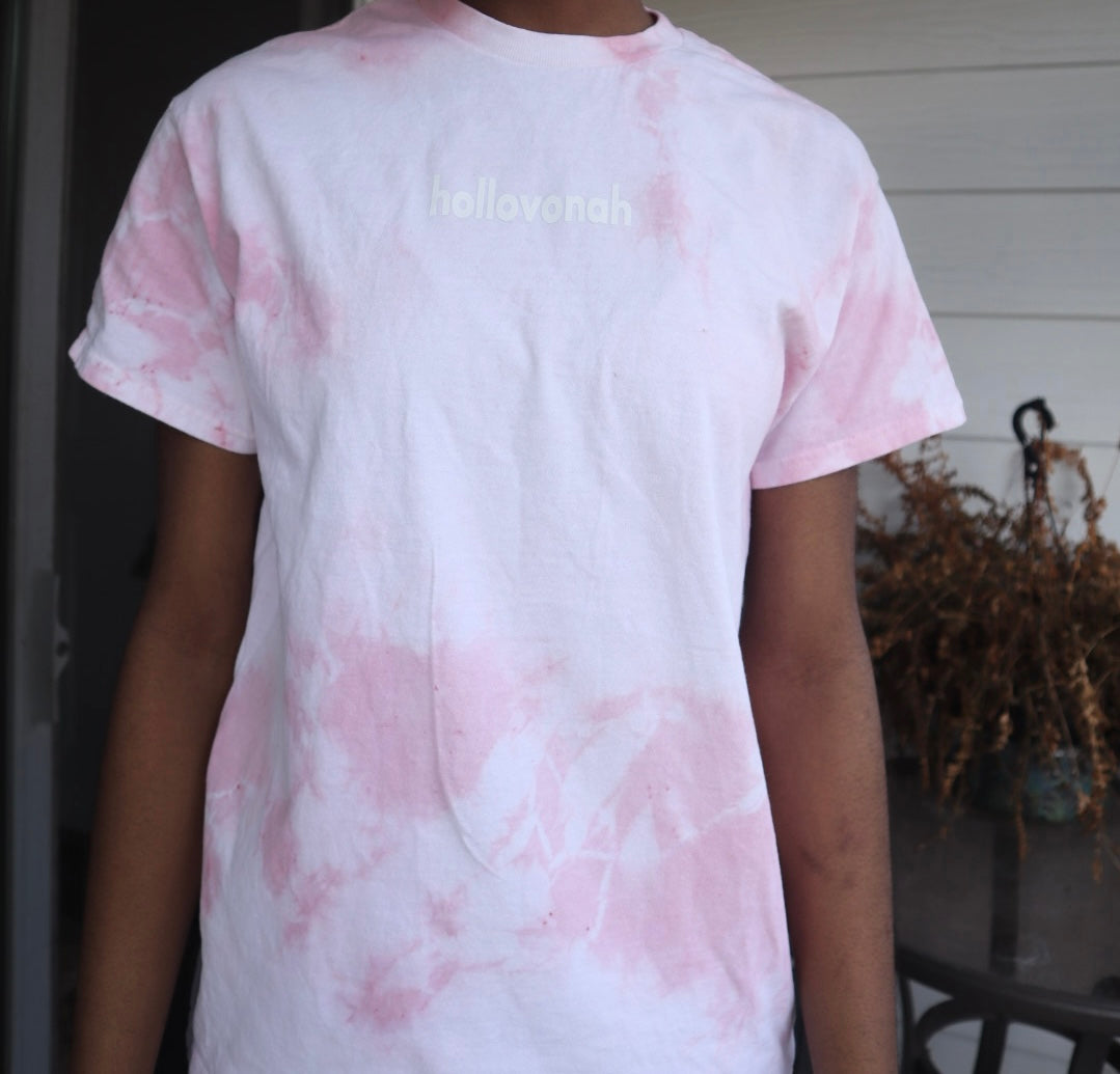 Person wearing a pink and white tie-dye t-shirt with 'hollovonah' text.