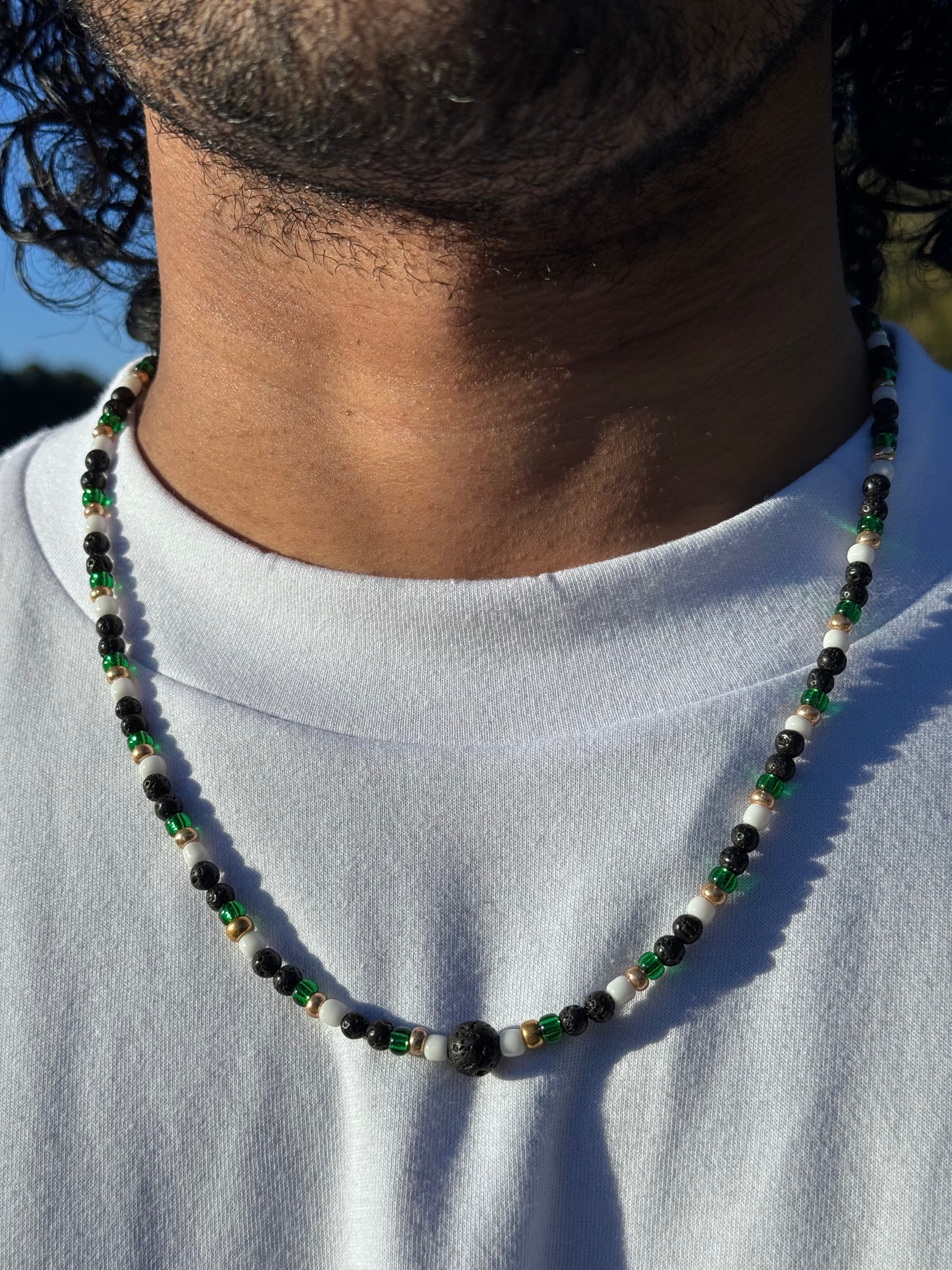 Necklace with multicolored beads on a white fabric background