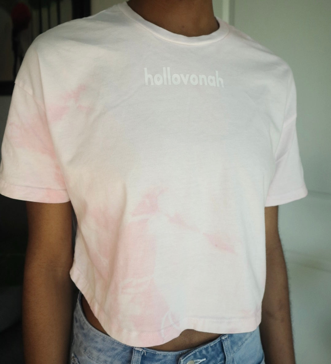Person wearing a tie-dye t-shirt with 'hollovonah' printed on it.