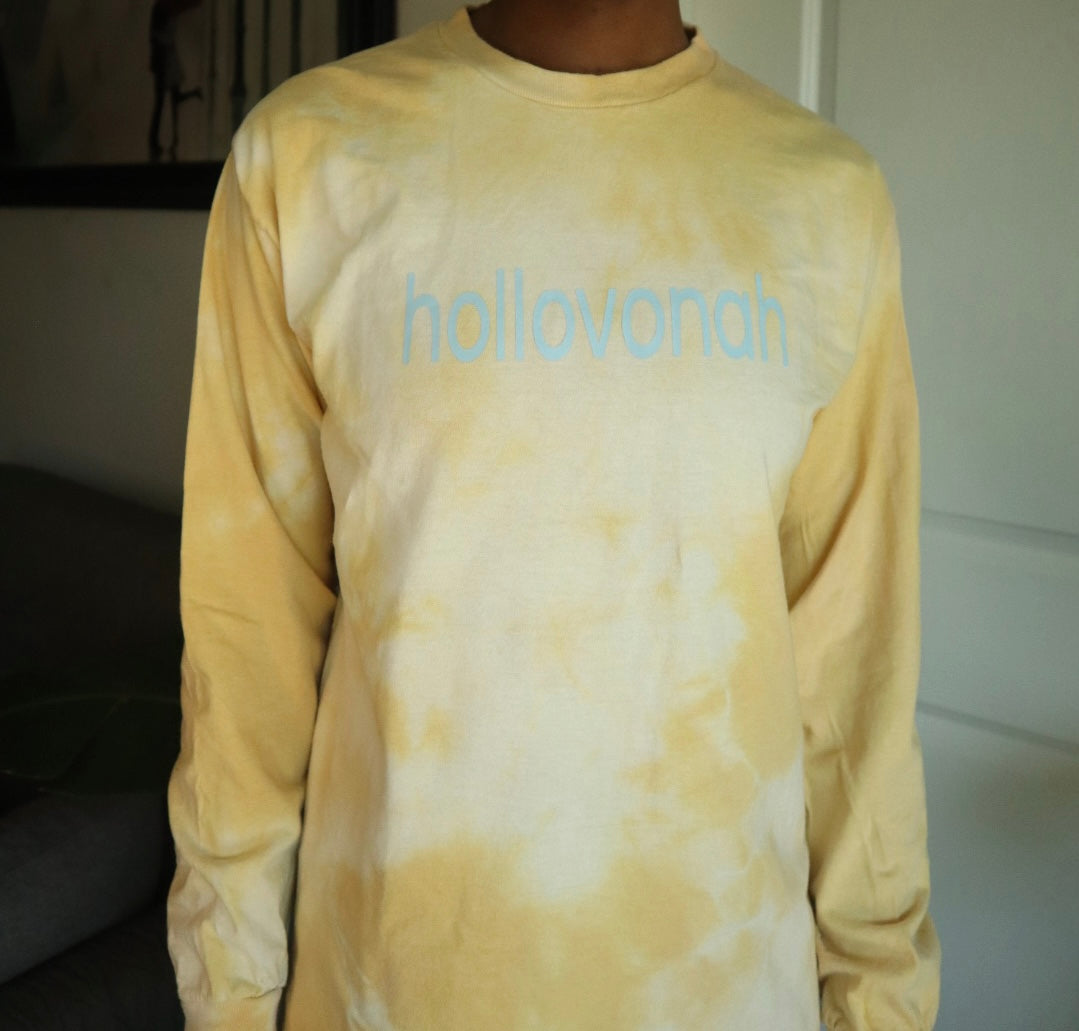 Yellow tie-dye long-sleeve shirt with 'hollovonah' text on a plain background