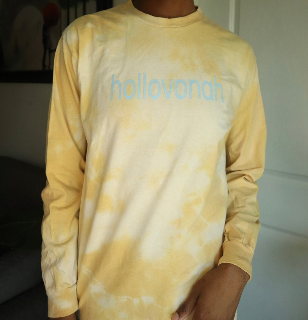 Person wearing a yellow tie-dye long-sleeve shirt with 'hollovonah' branding.