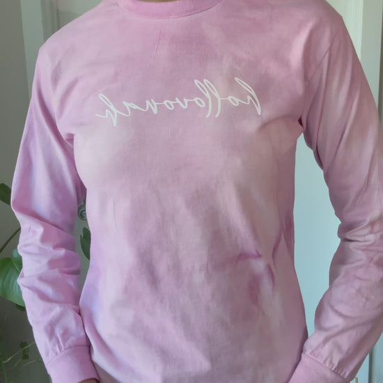 Person modeling a pink long sleeve shirt with the branding hollovonah.